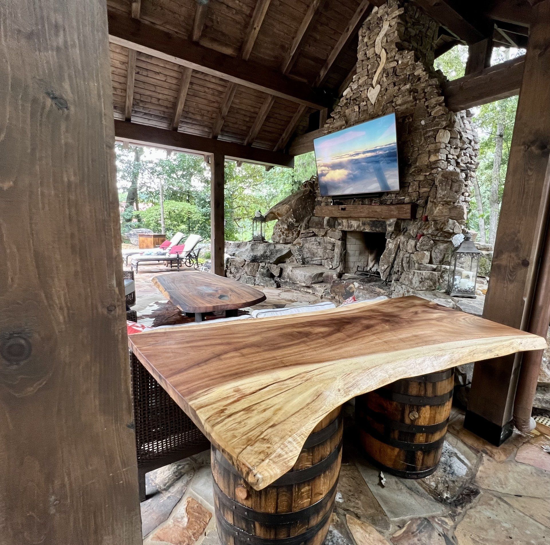 A wooden table is sitting on top of a wooden barrel.