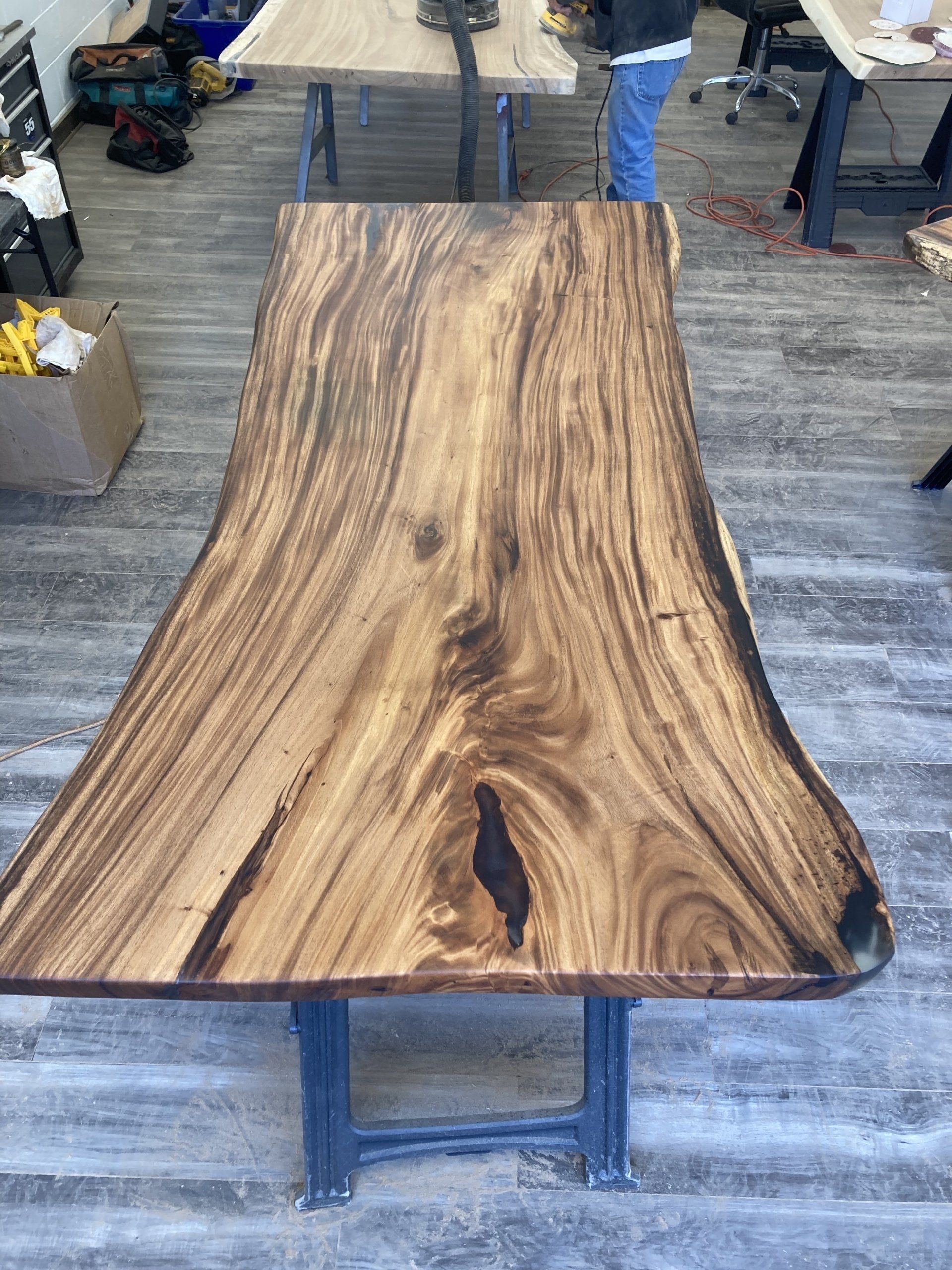 A large wooden table is sitting on a wooden floor in a room.