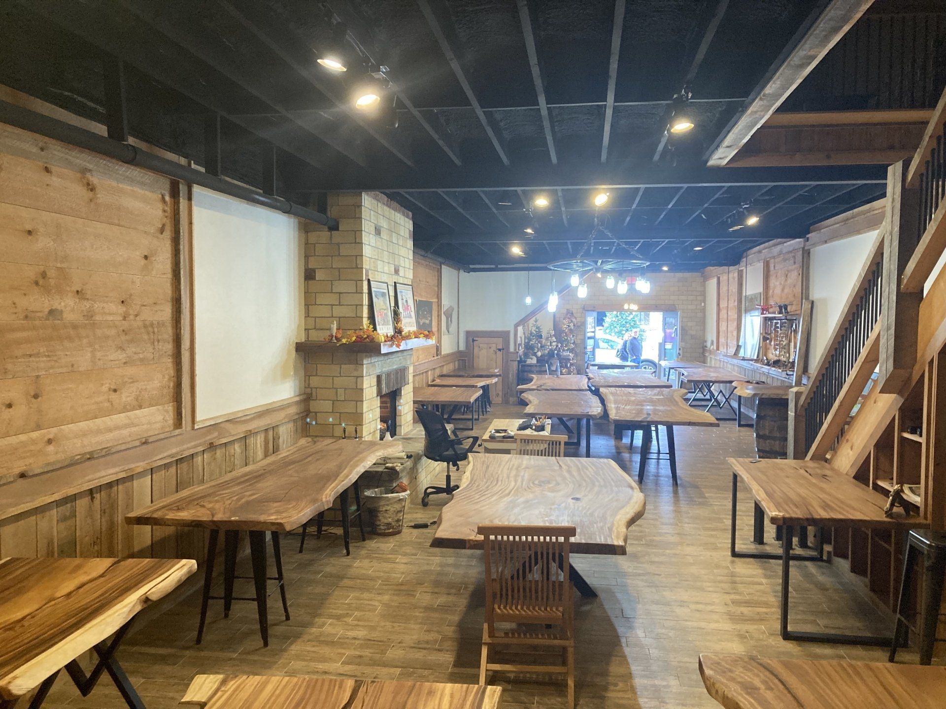 A large room filled with wooden tables and chairs.