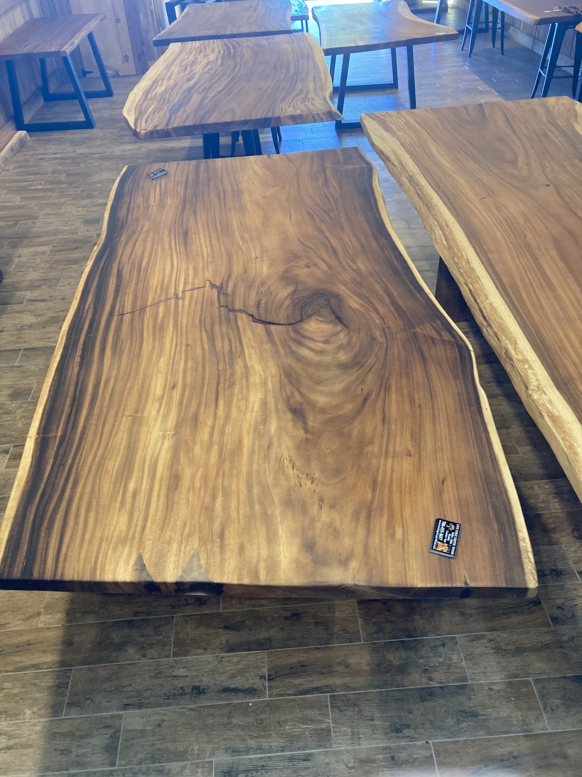 A large piece of wood is sitting on top of a wooden table.