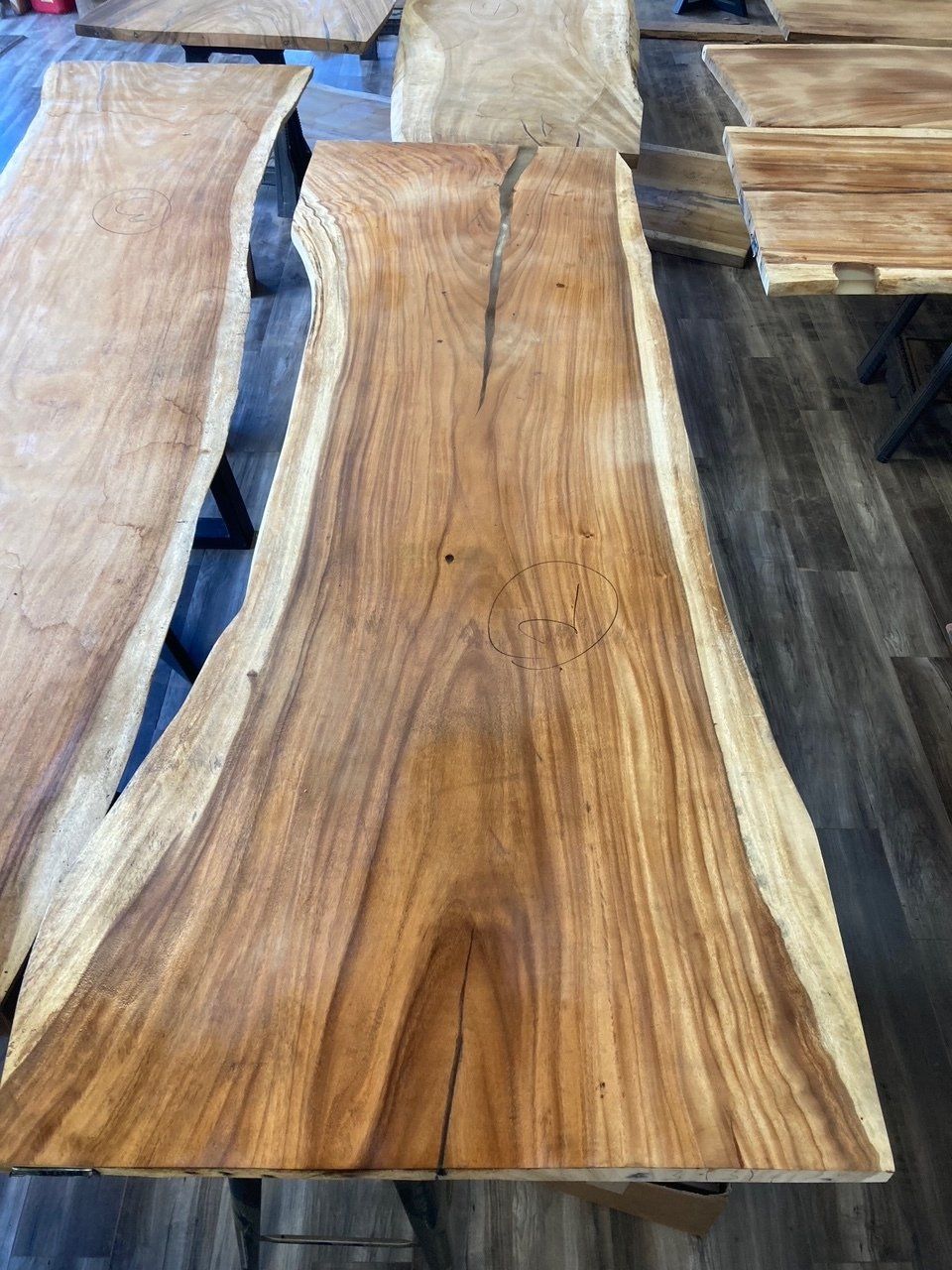 A large piece of wood is sitting on top of a wooden table.