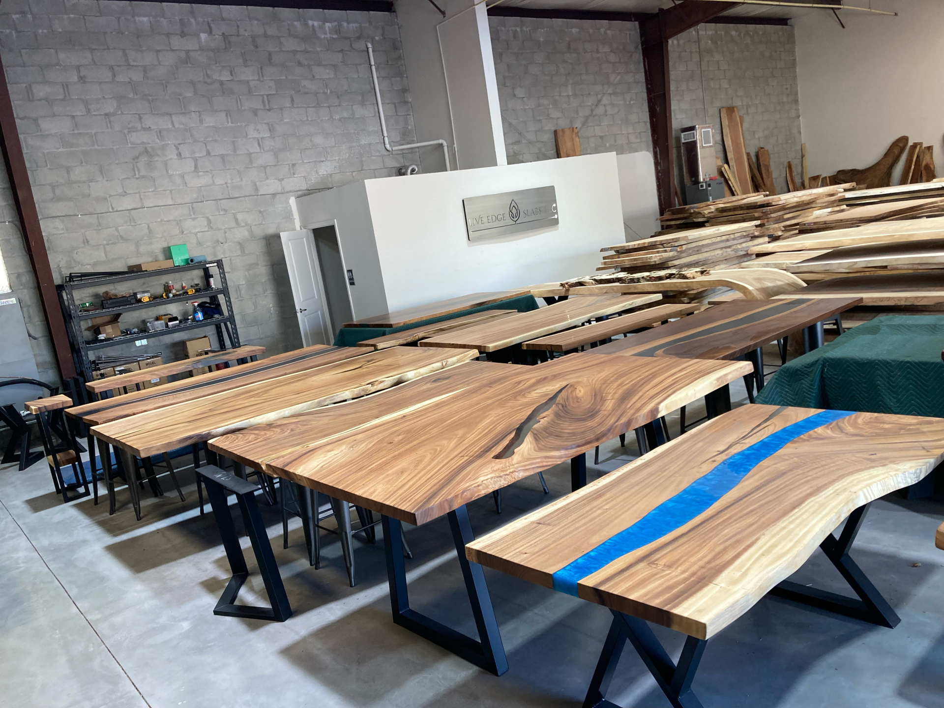 A warehouse filled with wooden tables and benches