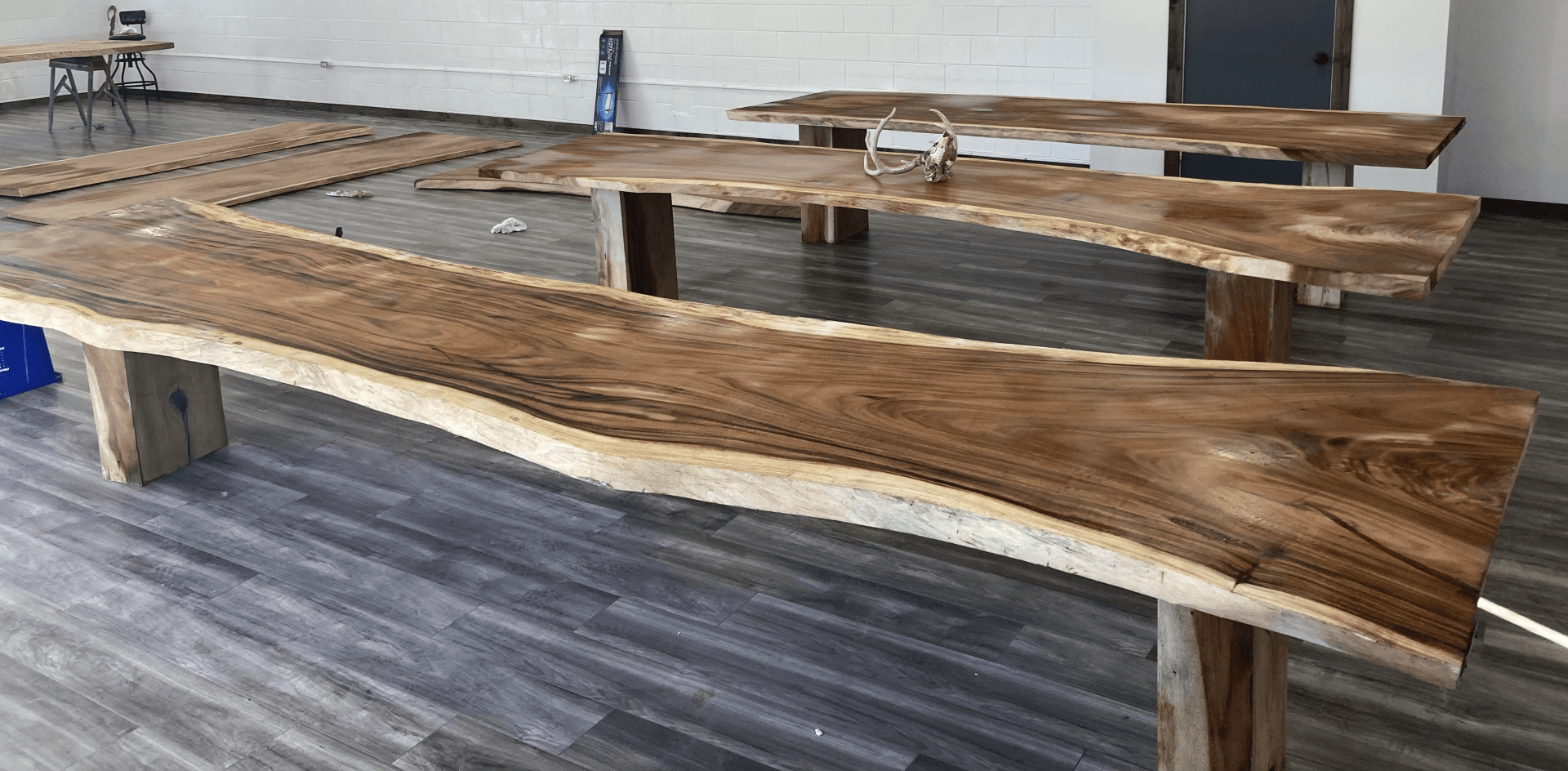 A large piece of wood is sitting on a wooden floor in a room.
