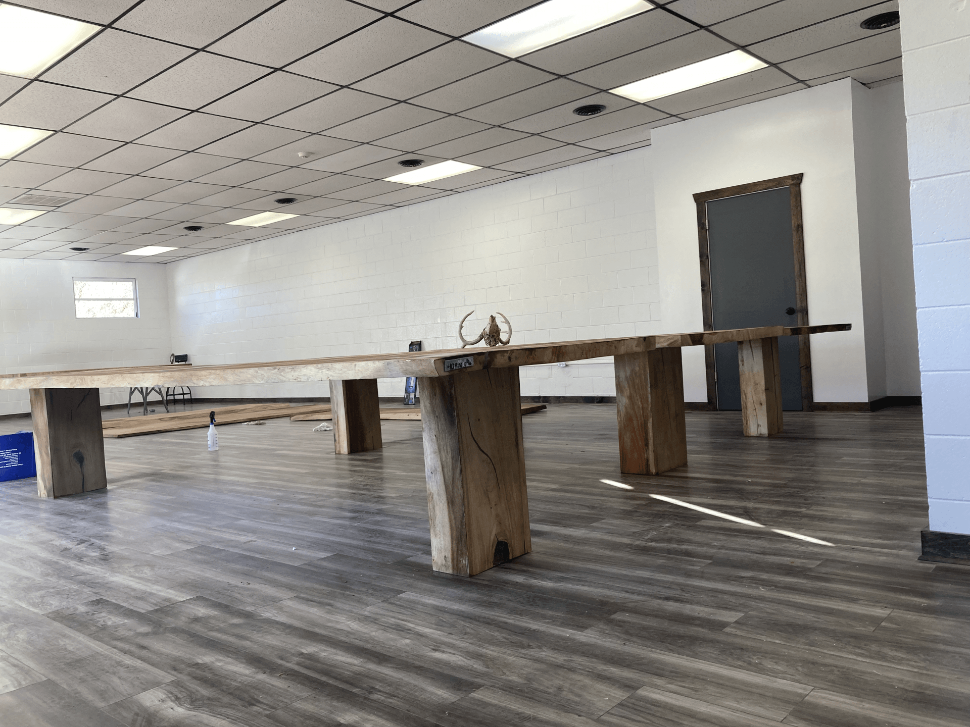 A large room with wooden benches and tables in it
