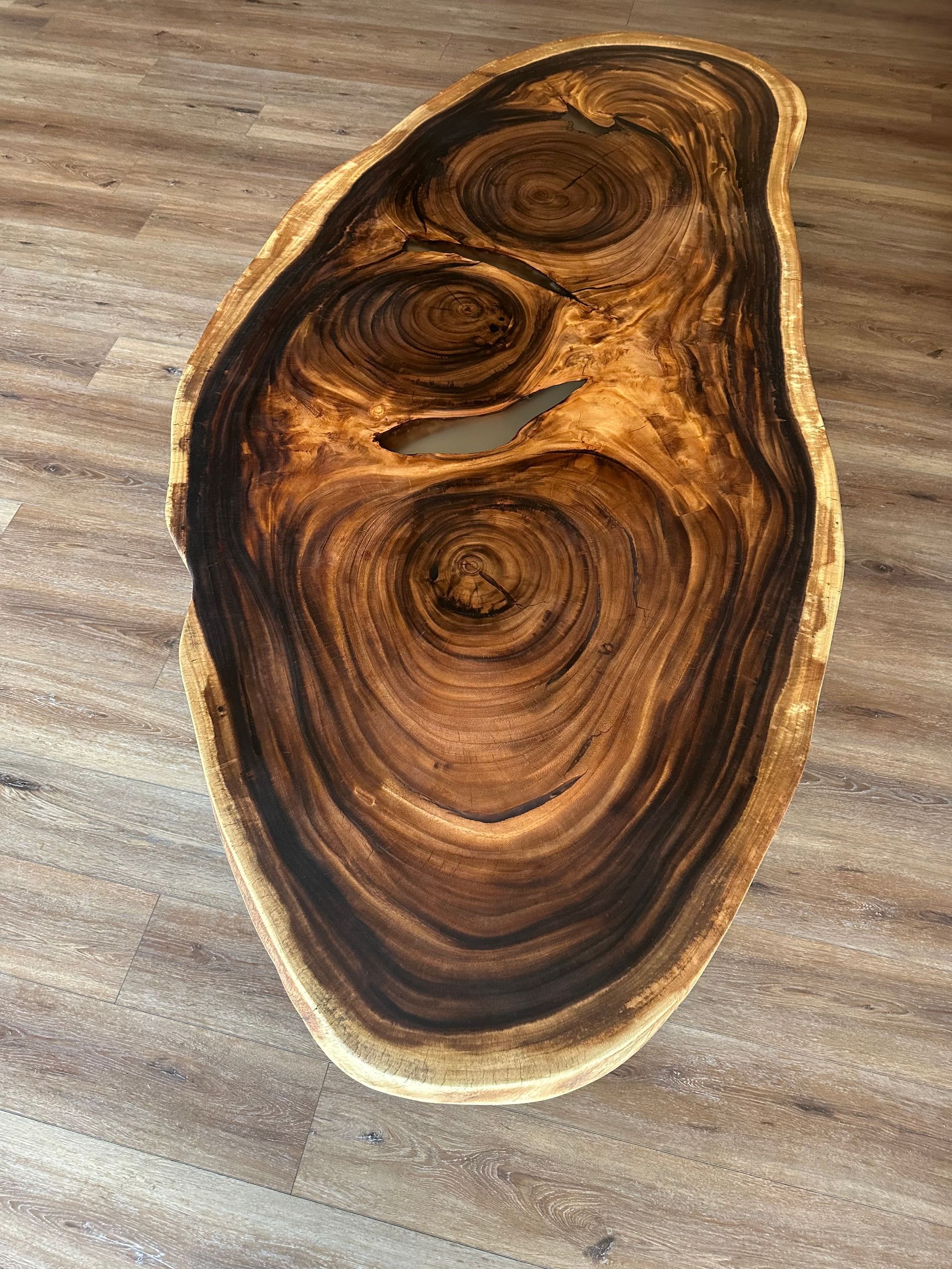 A large piece of wood is sitting on a wooden floor.