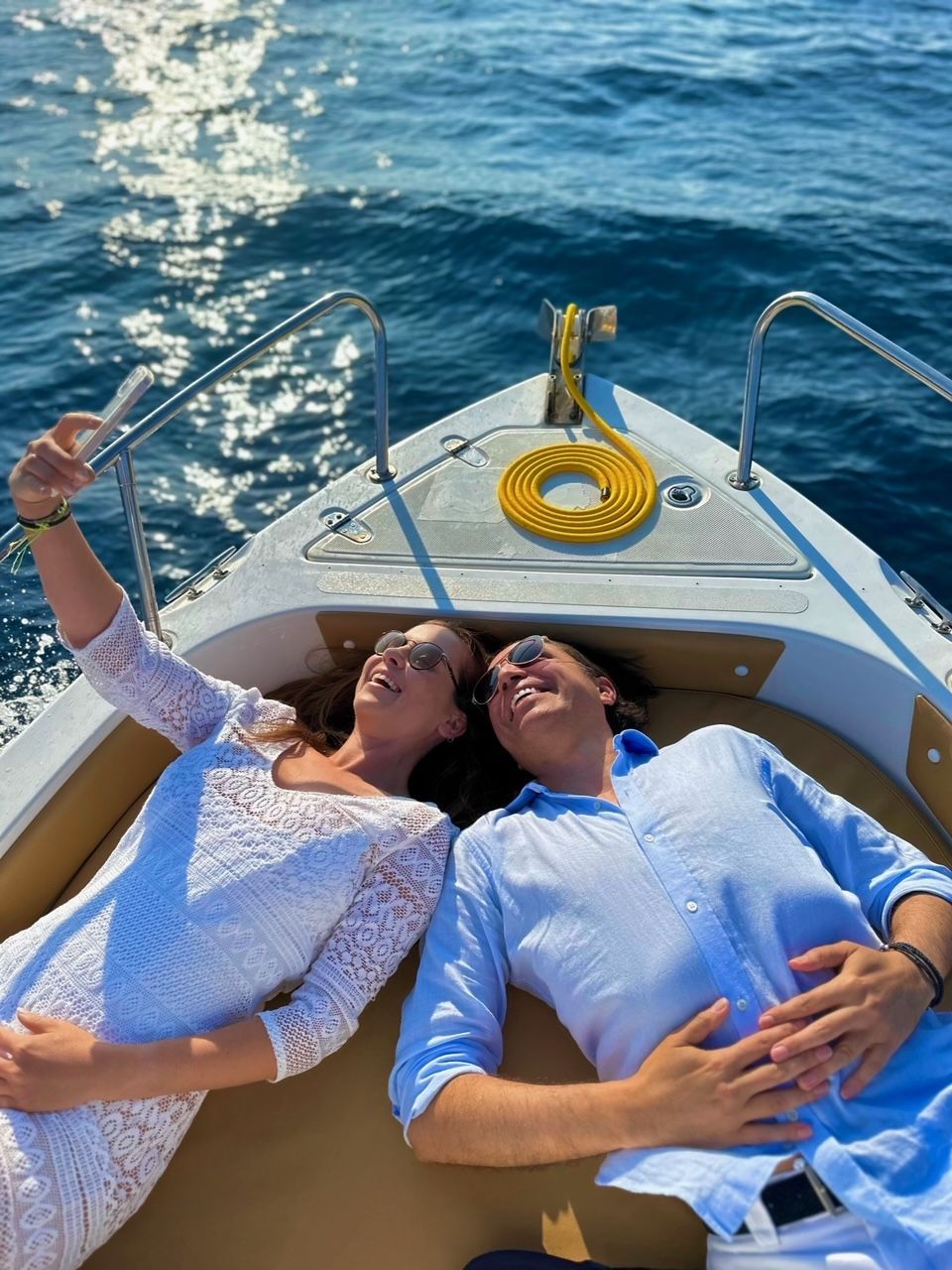 A couple taking selfies in a boat rented by SEAGOLD BOAT RENTALS
