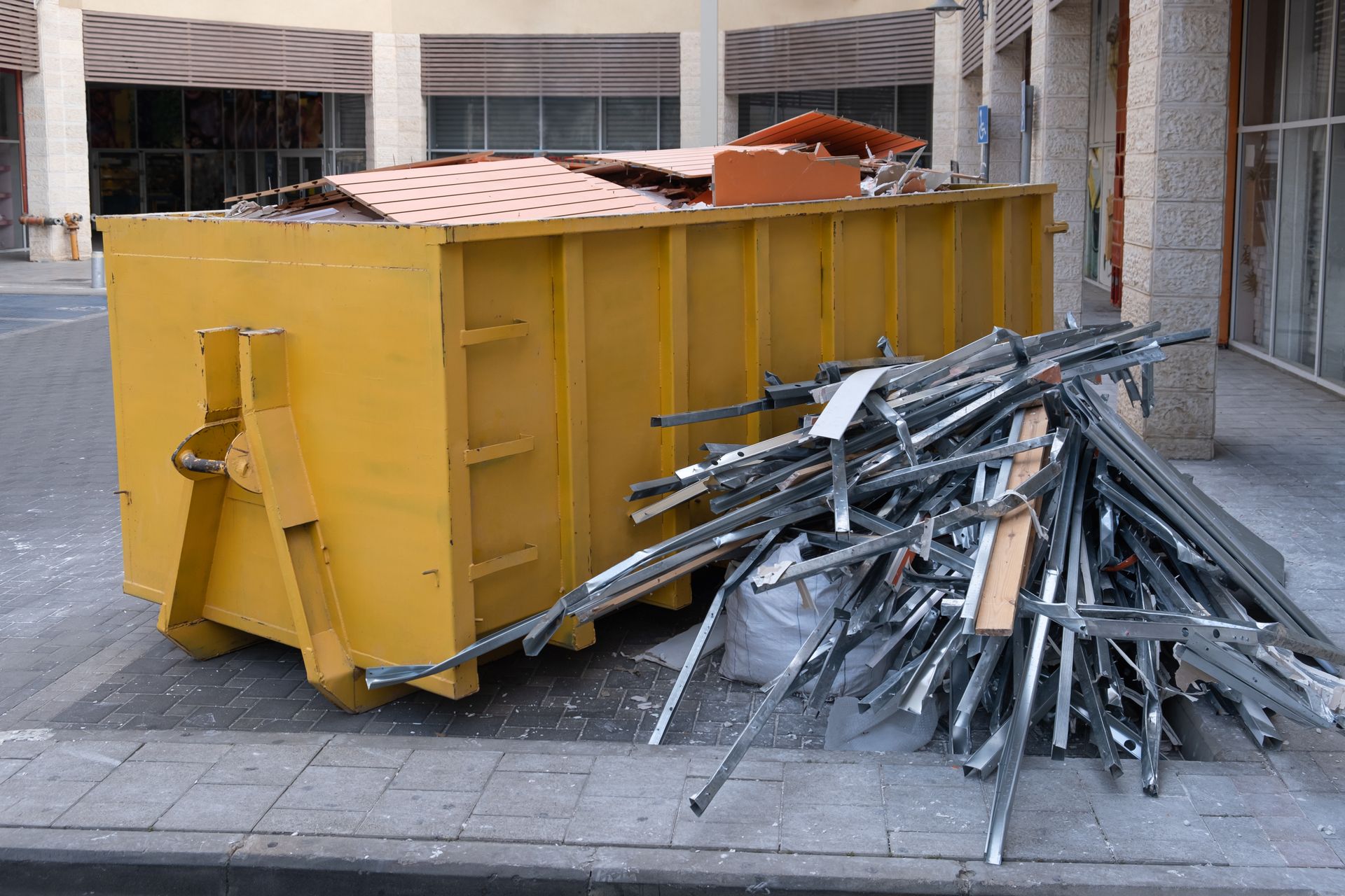 Dumpster filled with scrap metal, showcasing steel recycling efforts at a local recycling site.
