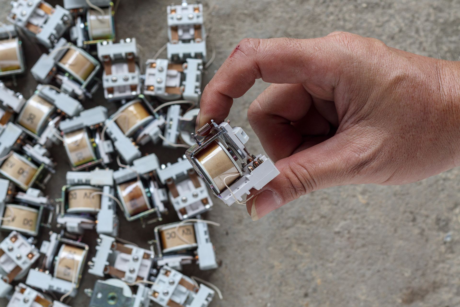 Hand holding copper electrical components for copper recycling services in Reading, PA.