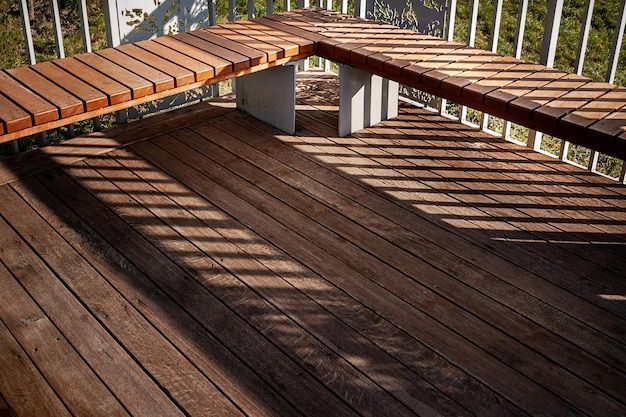 A wooden deck with a wooden bench on it