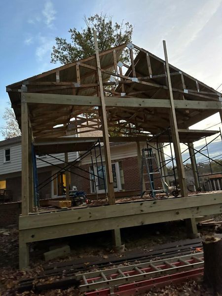 A house is being built with a wooden deck and scaffolding.