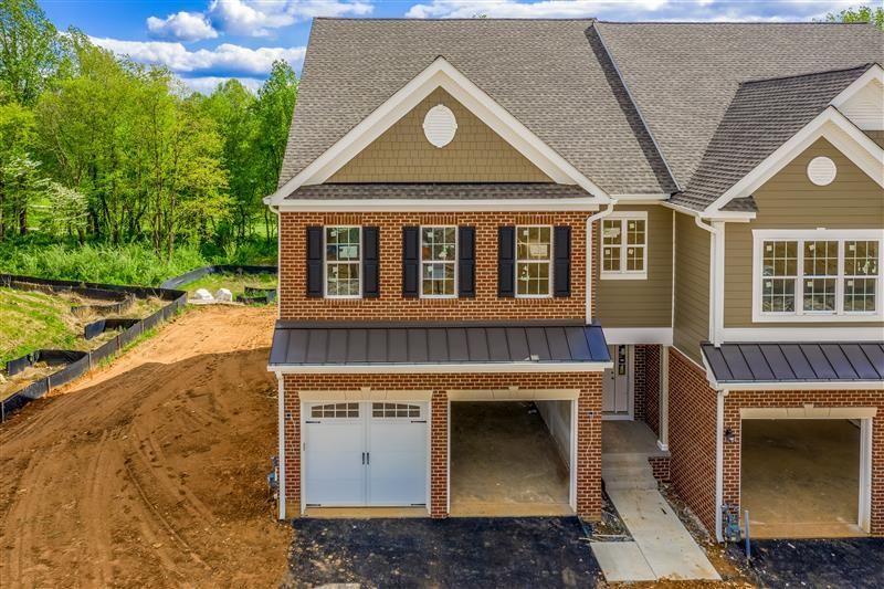 An aerial view of a house under construction with a lot of dirt in front of it.
