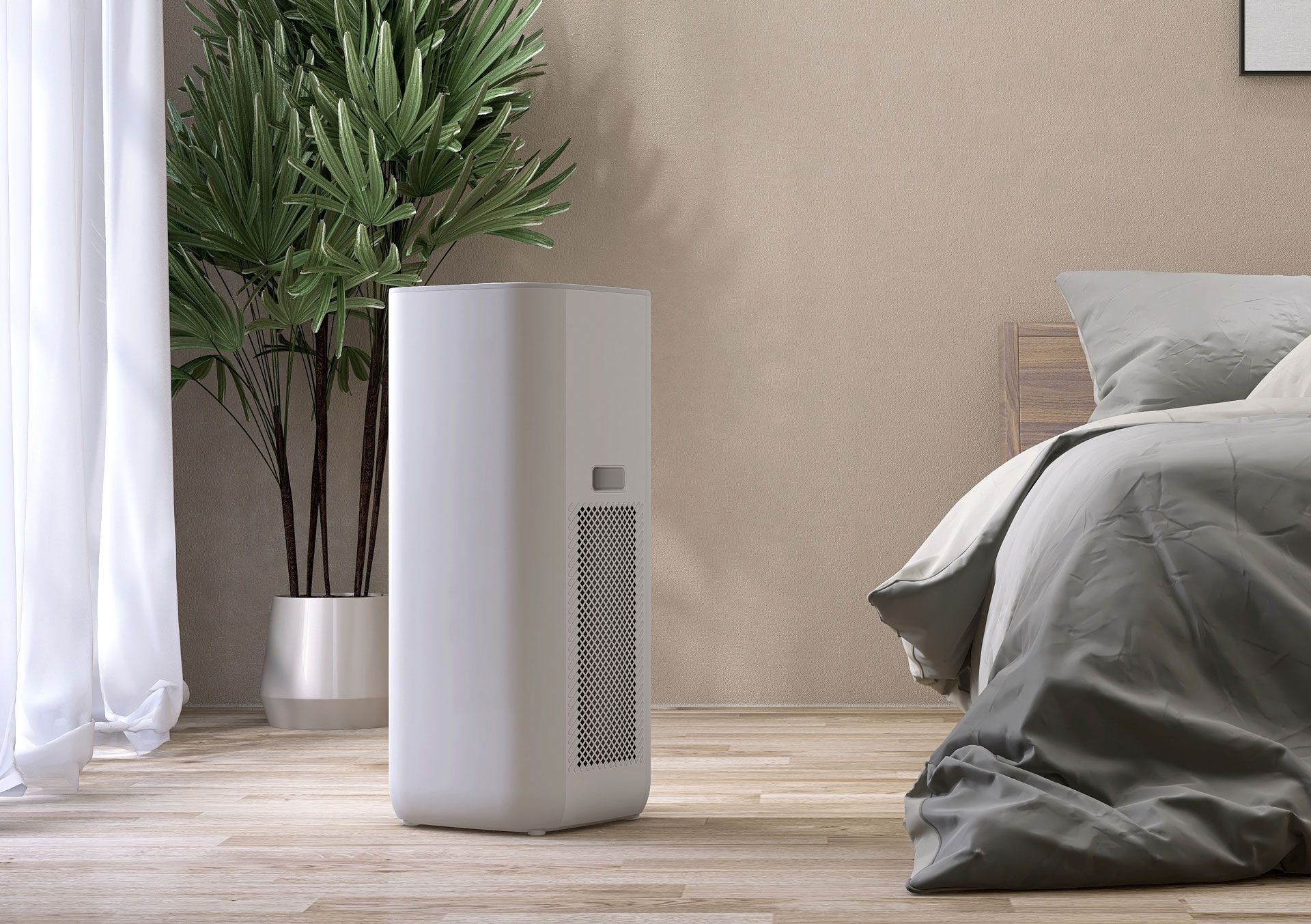 A white air purifier is sitting in a bedroom next to a bed.
