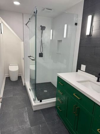 A bathroom with a toilet , sink , and shower.