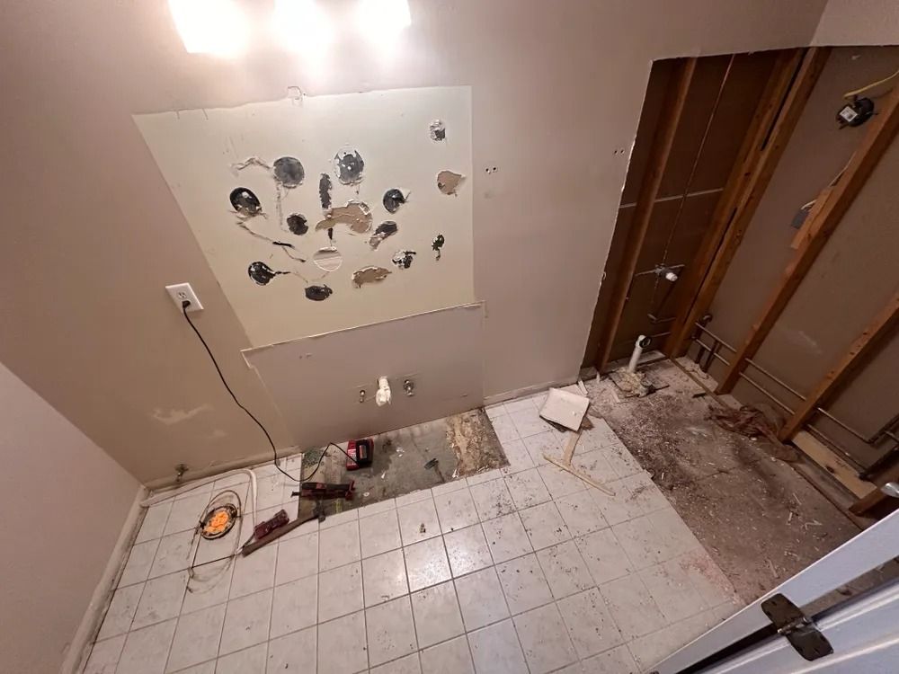A bathroom under construction with a large mirror on the ceiling.