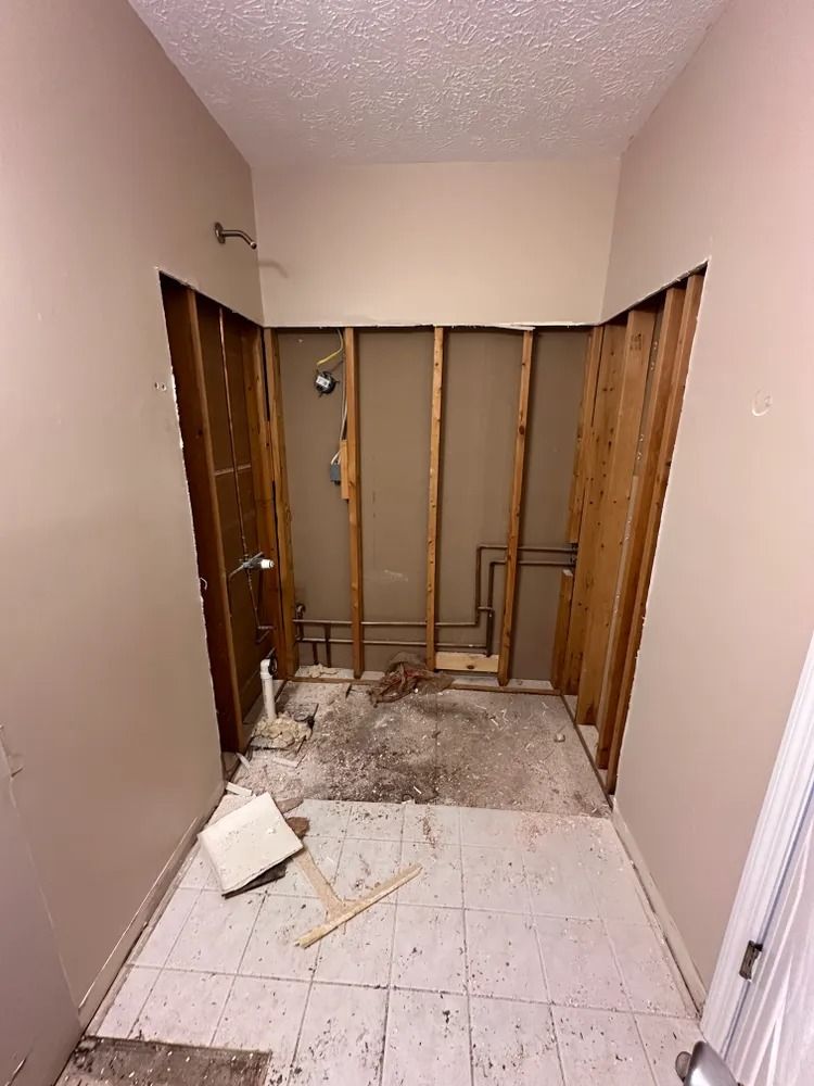 A bathroom under construction with wooden walls and tile floors.