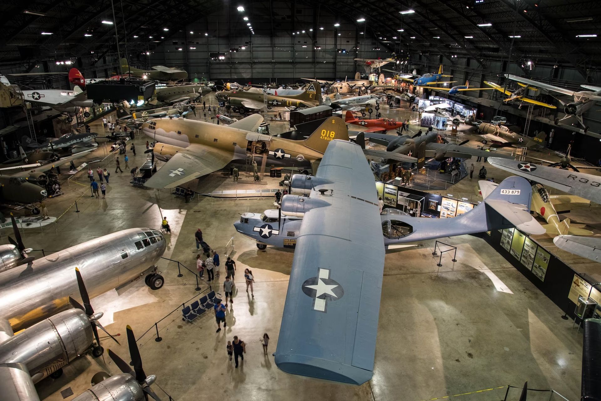 An aerial view of a museum filled with planes and people