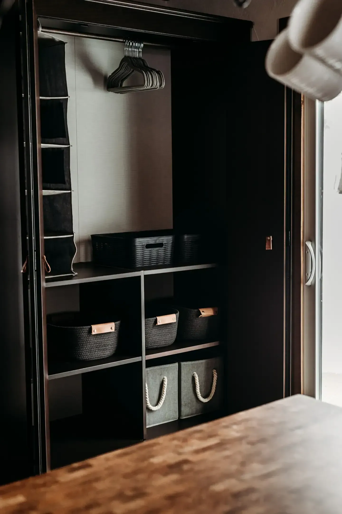 A closet with a lot of shelves and baskets in it.