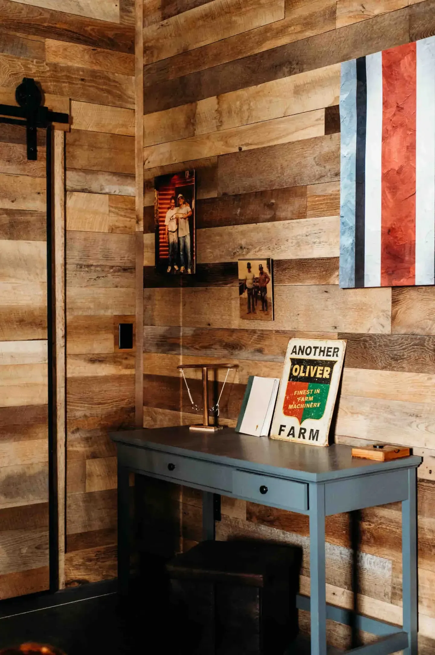 A room with wooden walls and a desk with a book on it.