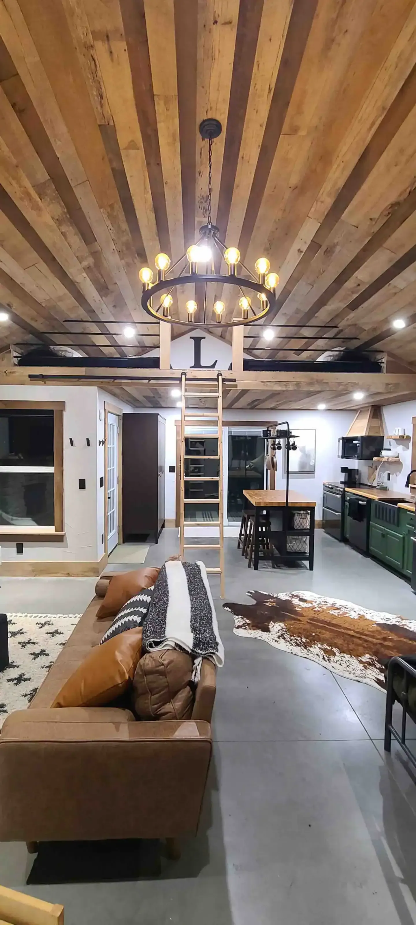 A living room with a couch and a chandelier.