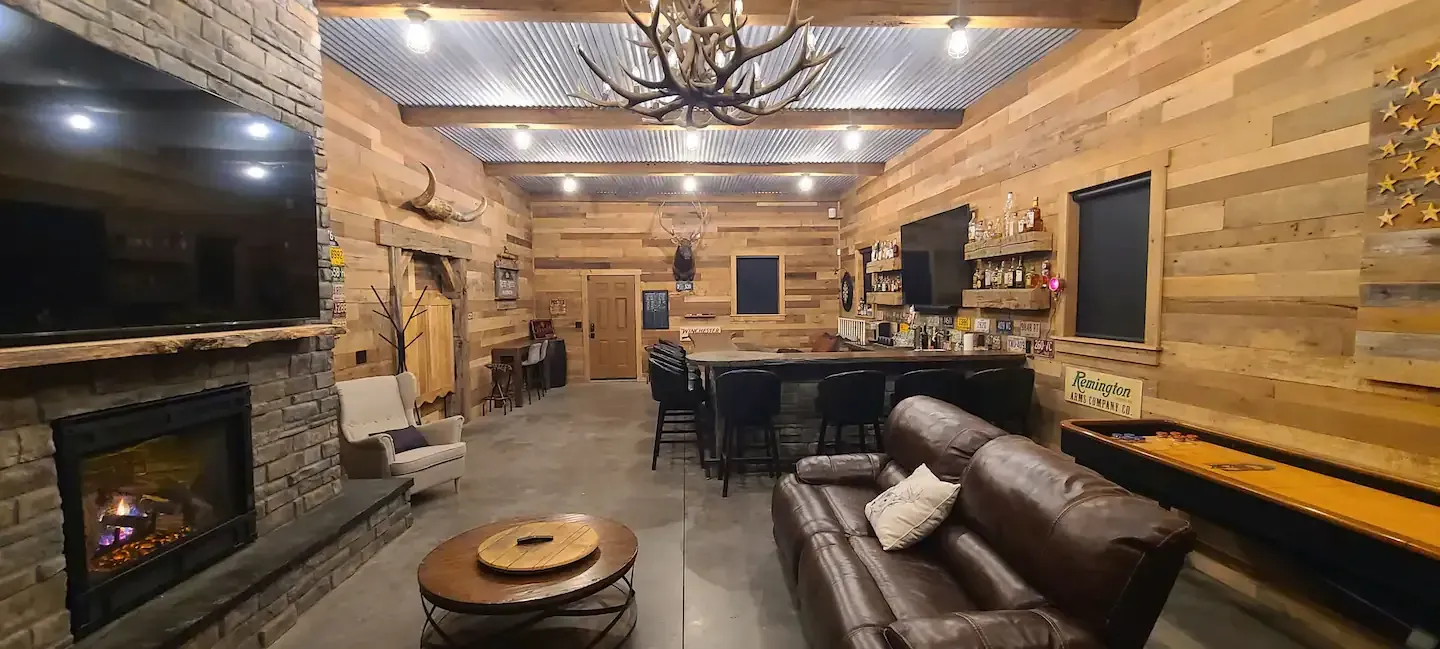 A living room with a couch , fireplace , table and television.