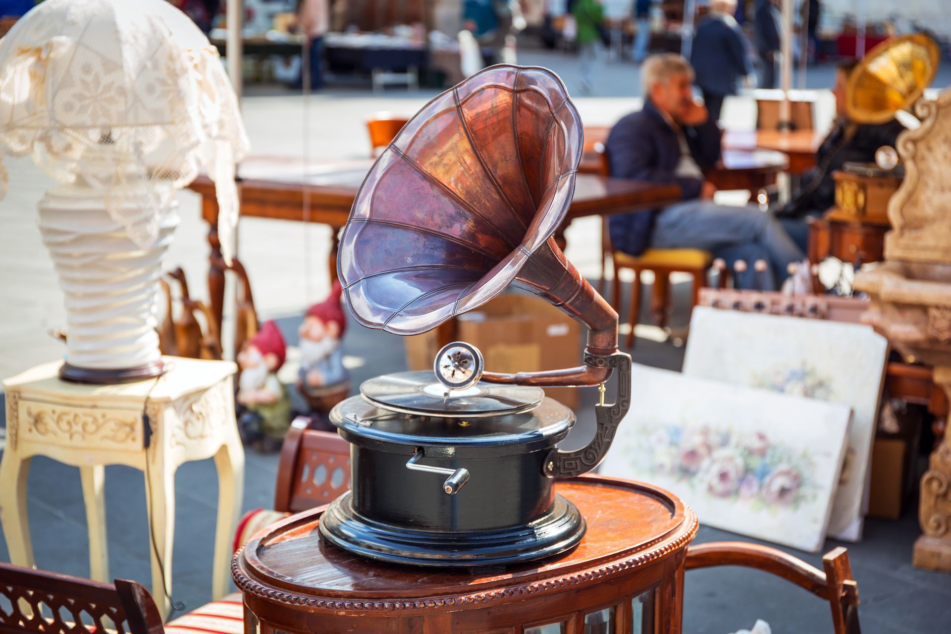 An old phonograph is sitting on top of a wooden table.