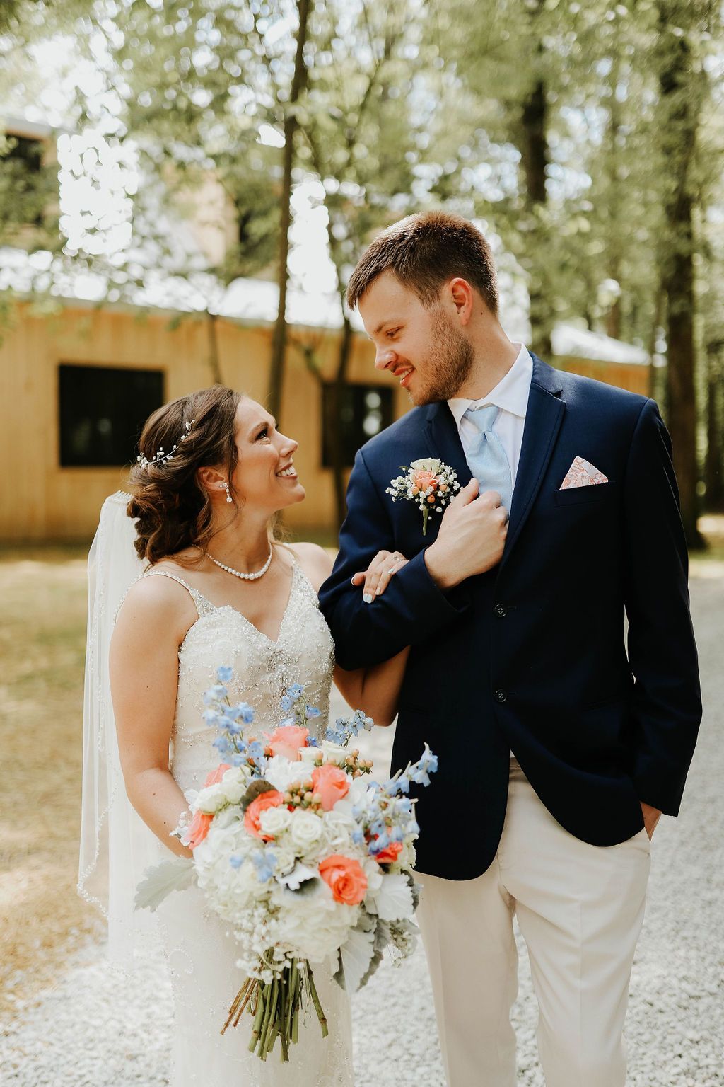 A bride and groom are posing for a picture on their wedding day.