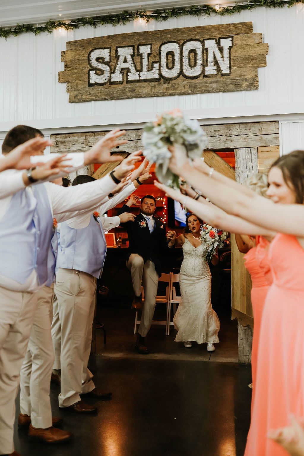A bride and groom are entering a saloon with their wedding party.
