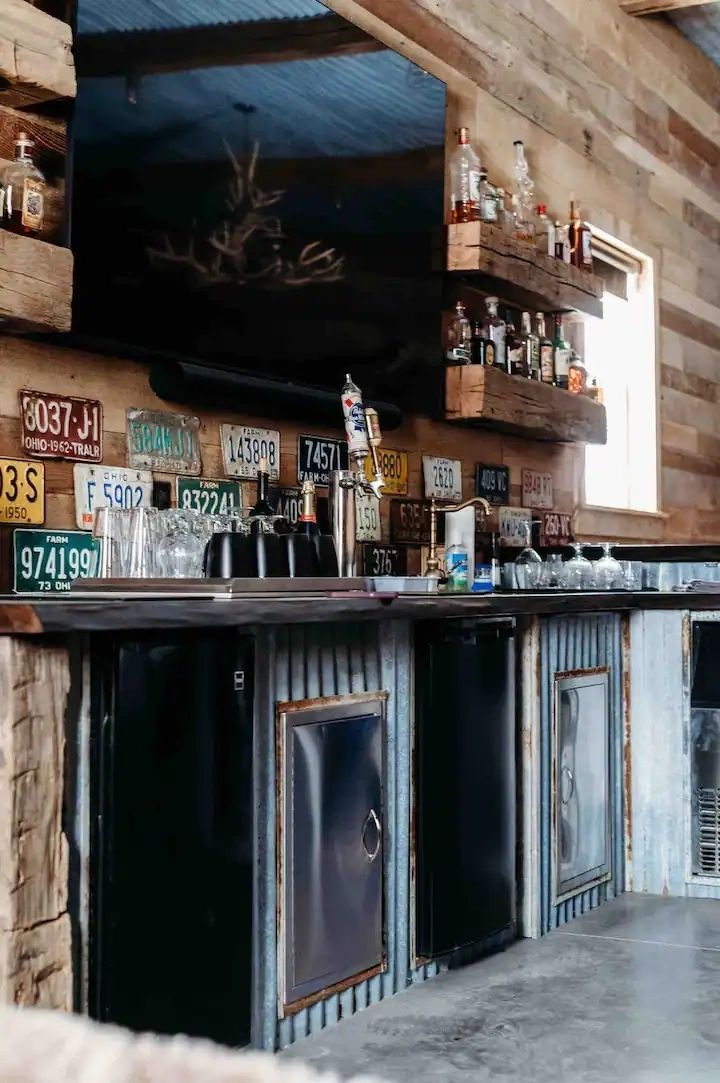 A kitchen with a wooden counter top and a stainless steel refrigerator.