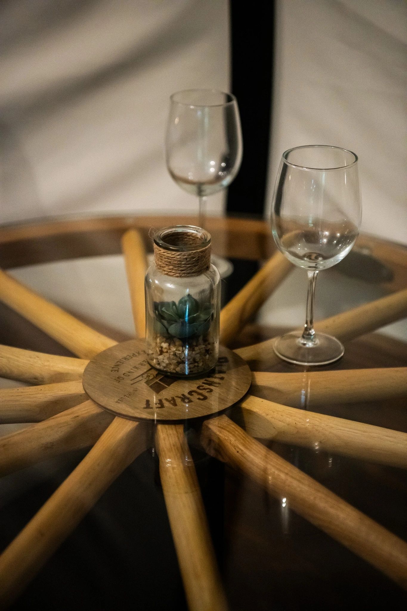 Two wine glasses are sitting on a wooden table.