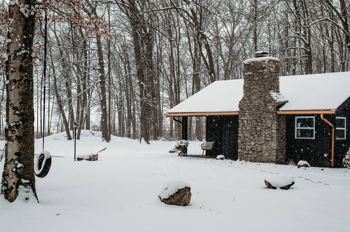 A small house in the middle of a snowy forest