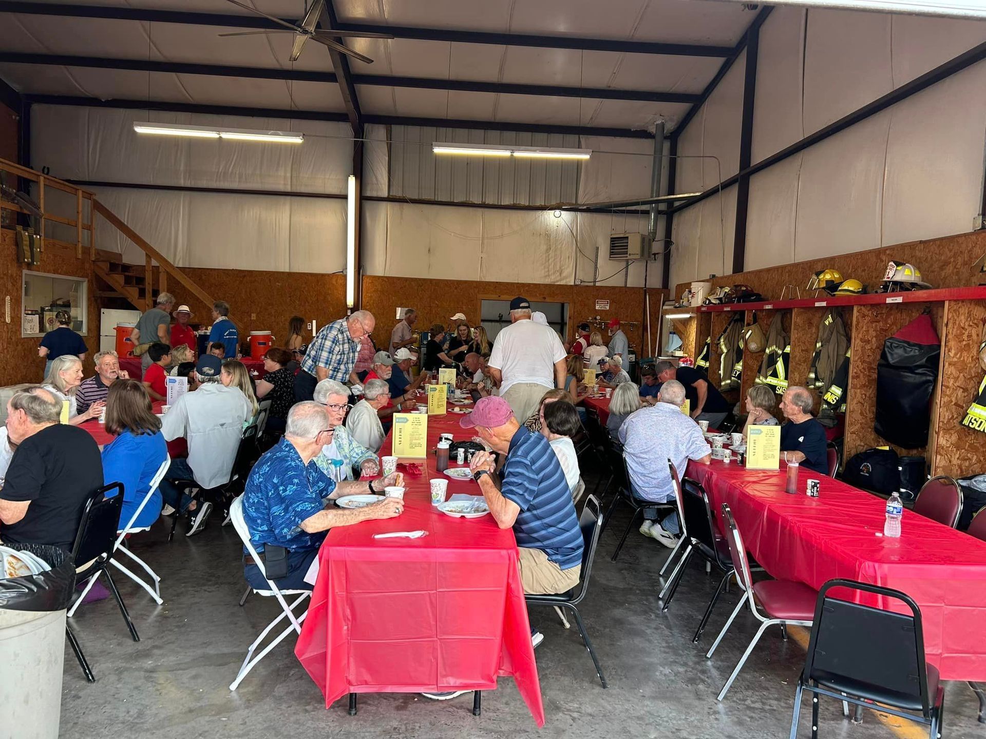 A group of people are sitting at tables in a room.