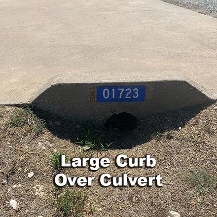 A large curb over culvert with the number 01723 on it