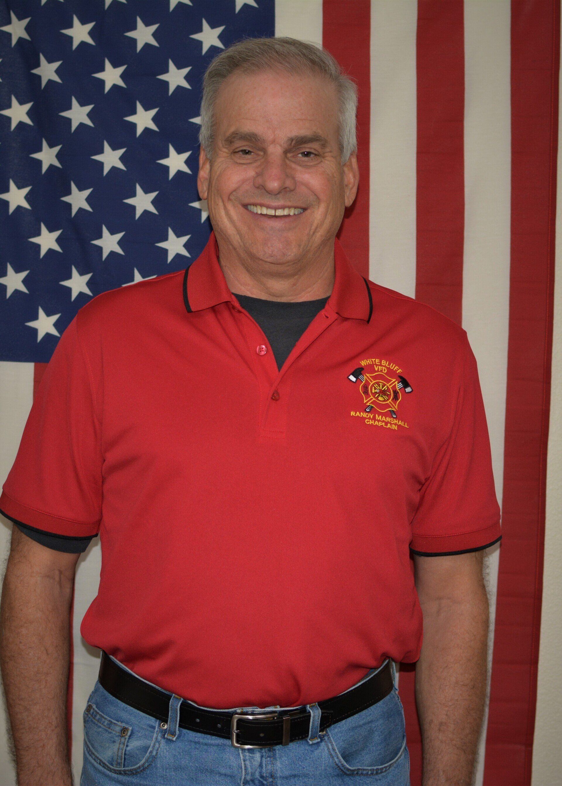 A man wearing a red shirt with the word fire on it