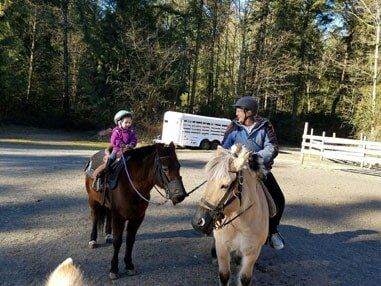 Teacher leading young girl on horse - Horse riding lessons in Olalla WA