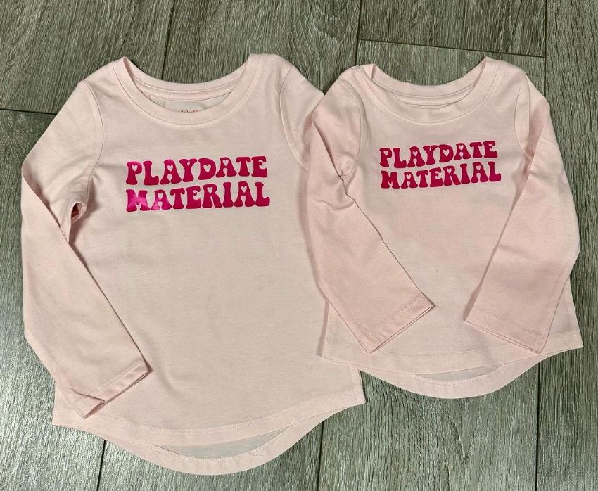 Two pink shirts that say playdate material on them