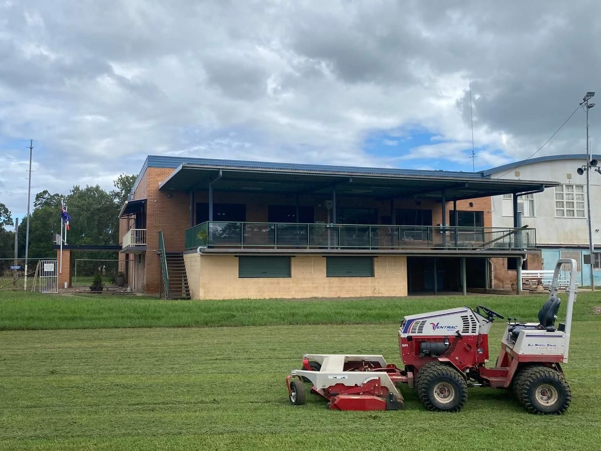 A Lawn Mower is Parked in Front of a Building — 4WD Slashing & Large Area Mowing In Alstonville, NSW