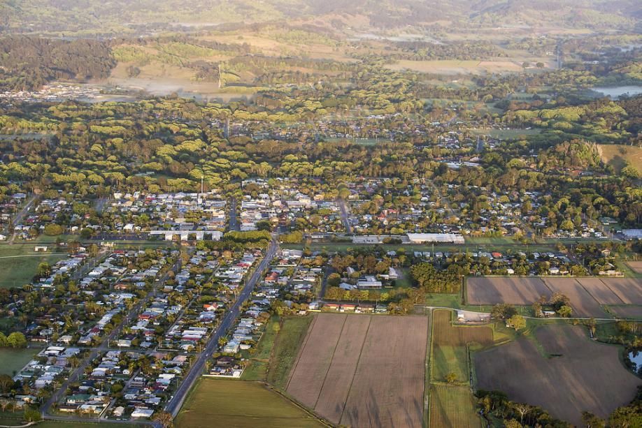 An Aerial View of a Residential Area Surrounded by Fields and Trees — 4WD Slashing & Large Area Mowing In Mullumbimby, NSW