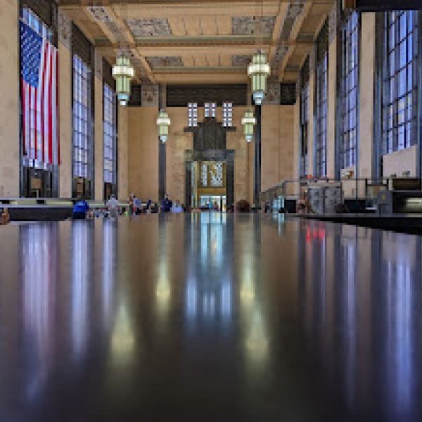 A large room with a lot of windows and a table in the middle of it.