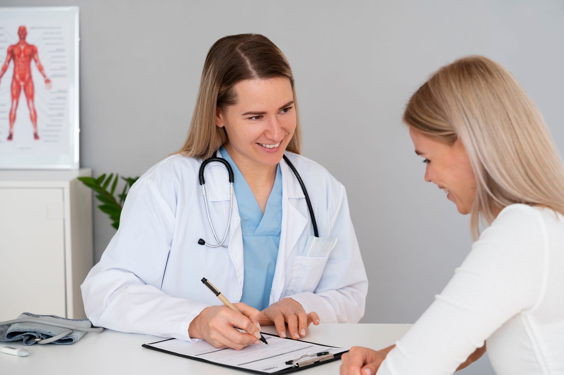 Doctor consulting with a patient at a desk in a bright medical office