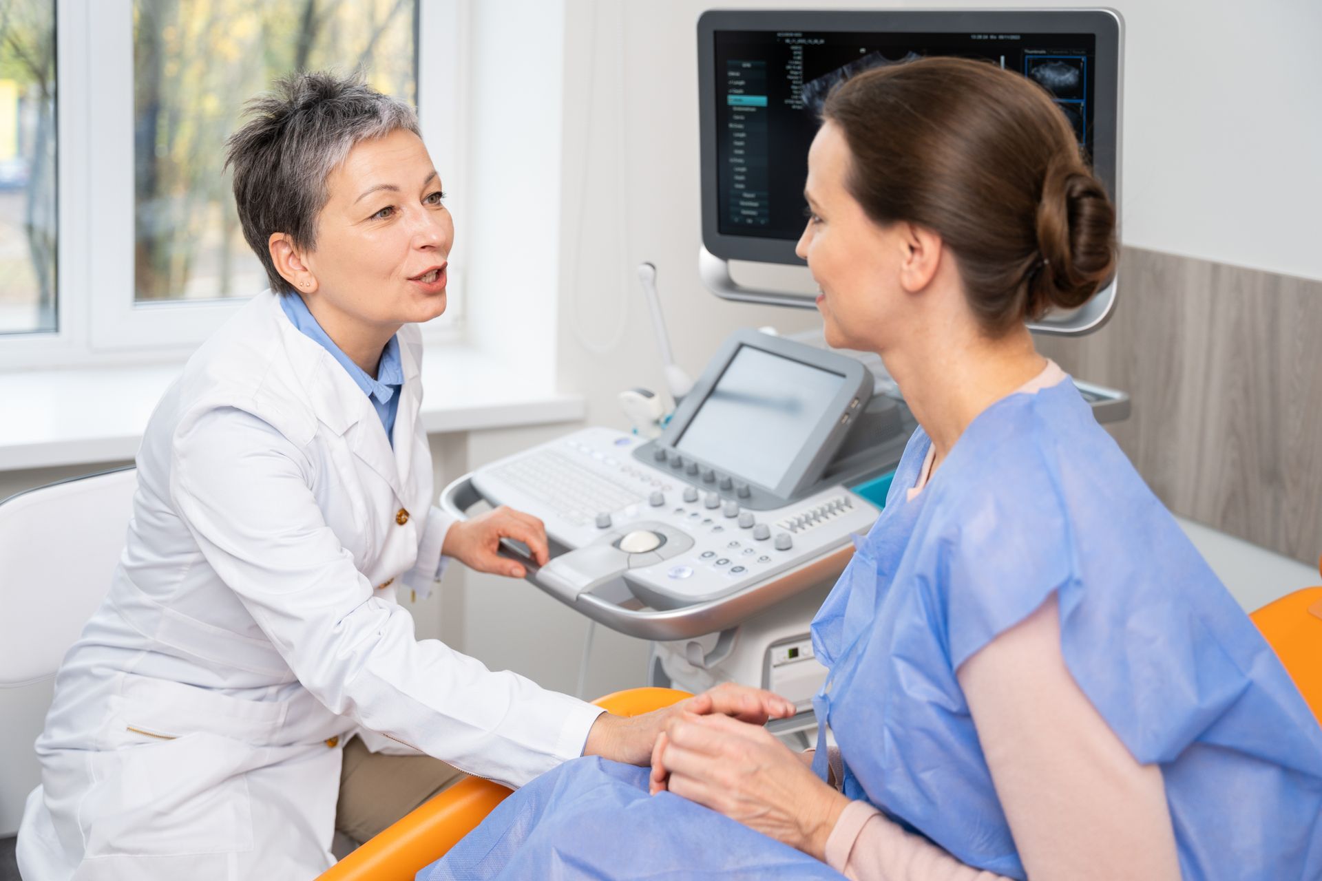 Doctor discussing an ultrasound with a patient in a clinic