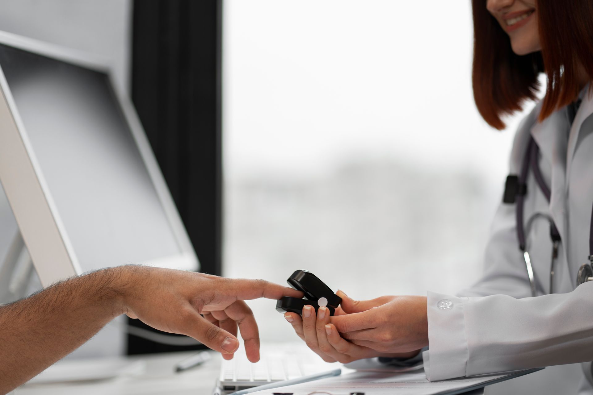 Doctor handing a medication cup to a patient at a clinic desk