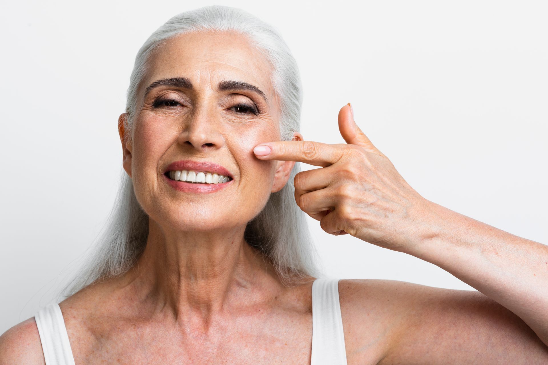A woman is getting a botox injection on her forehead