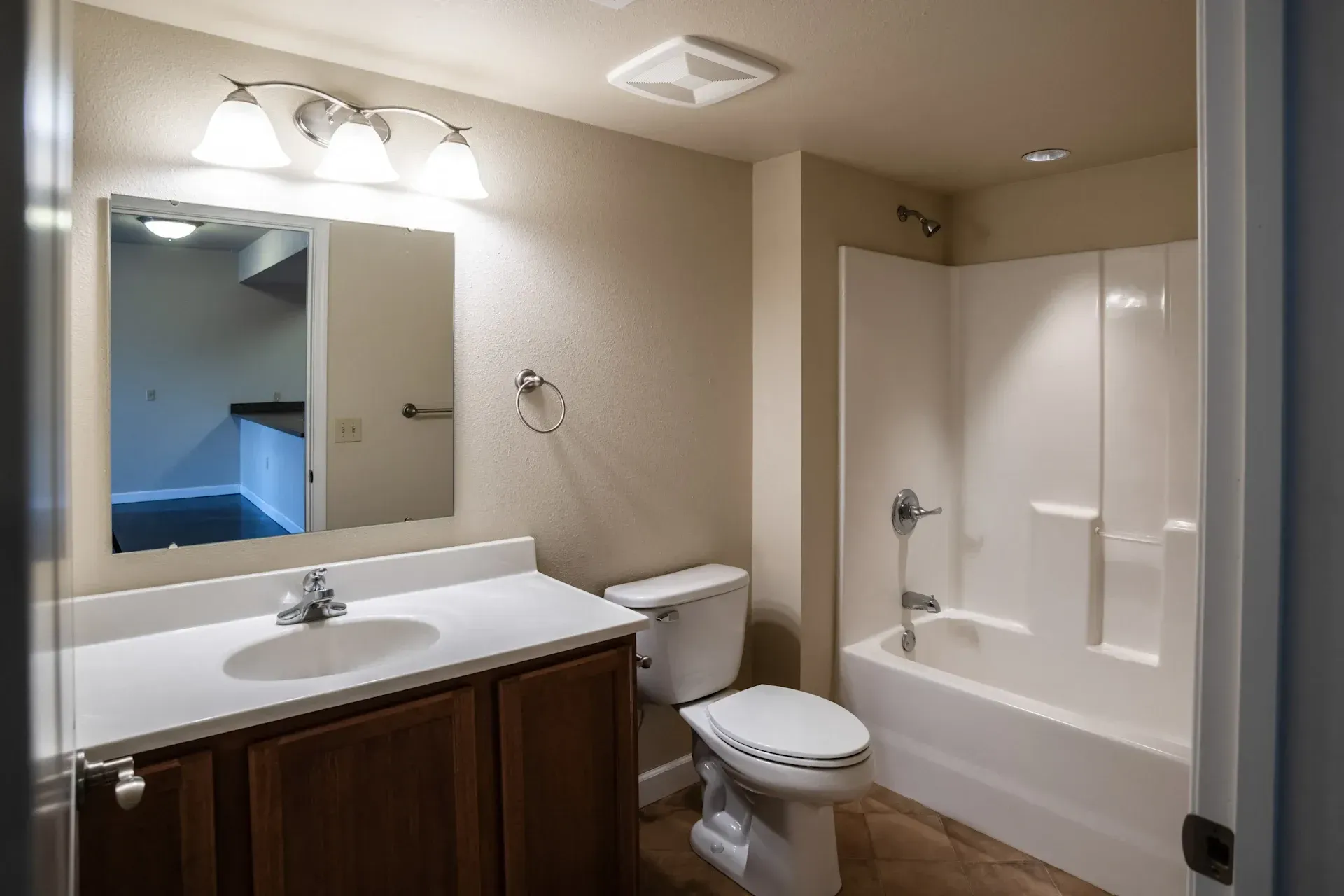 A bathroom with a toilet , sink , and bathtub.