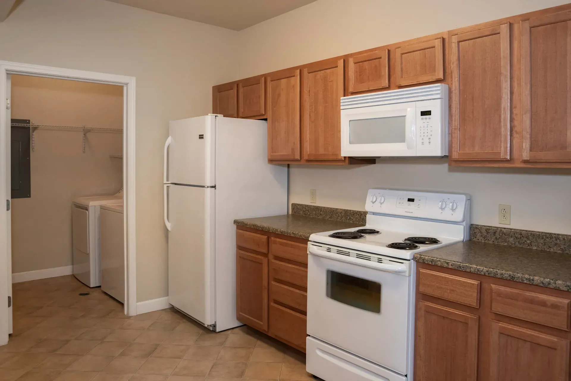 A kitchen with a refrigerator stove and microwave