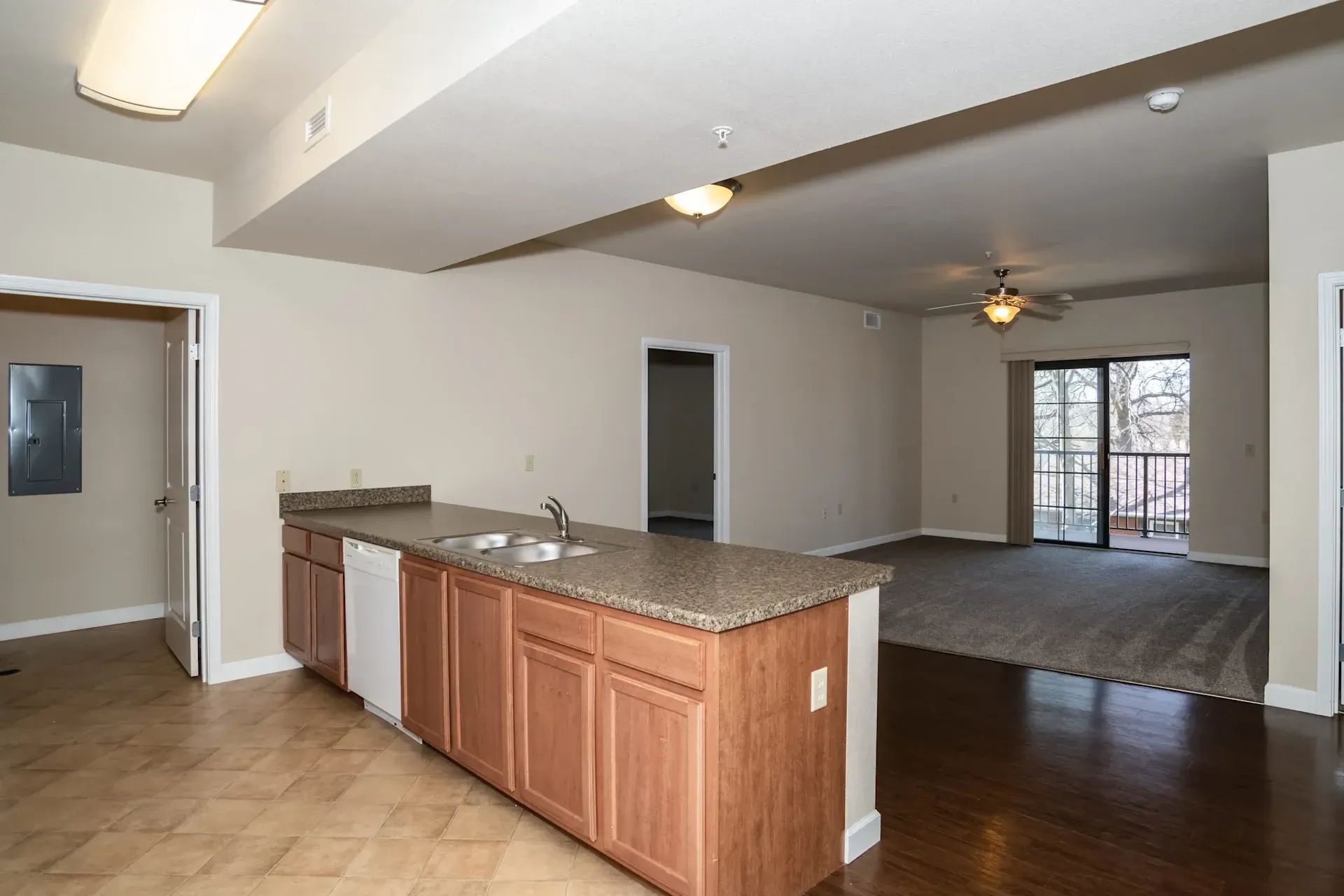 An empty apartment with a kitchen and a living room