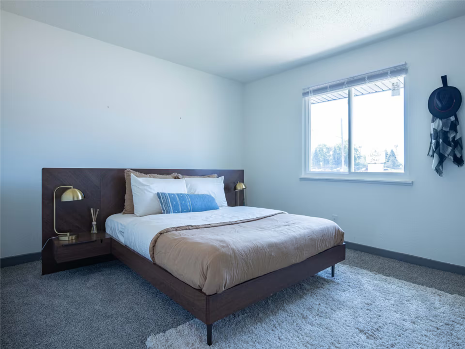 A bedroom with a large bed and a window.