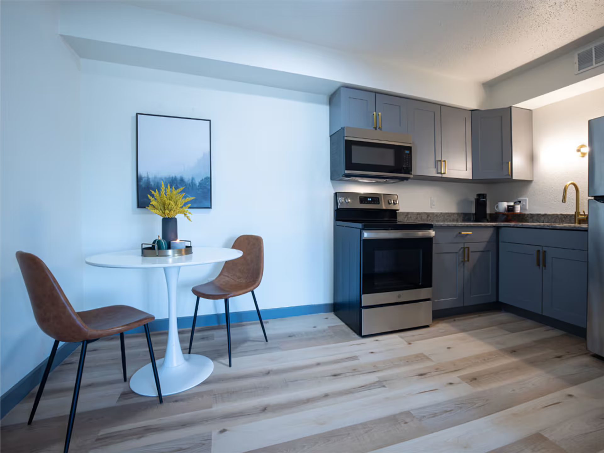 A kitchen with a table and chairs in it.
