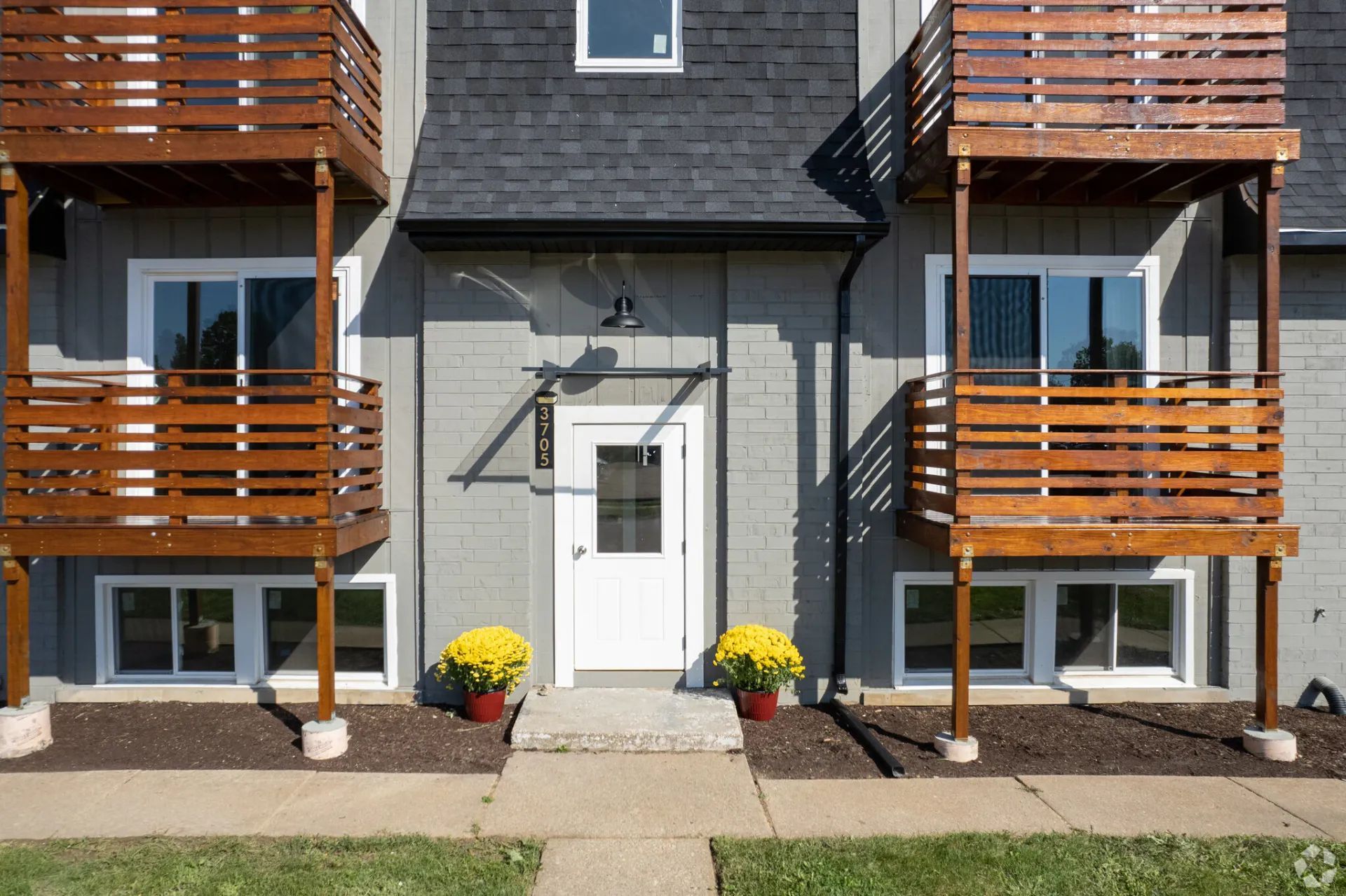 A building with a white door and wooden balconies