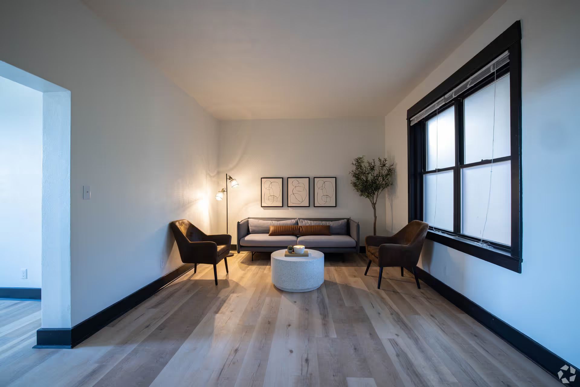 A living room with a couch , chairs and a coffee table