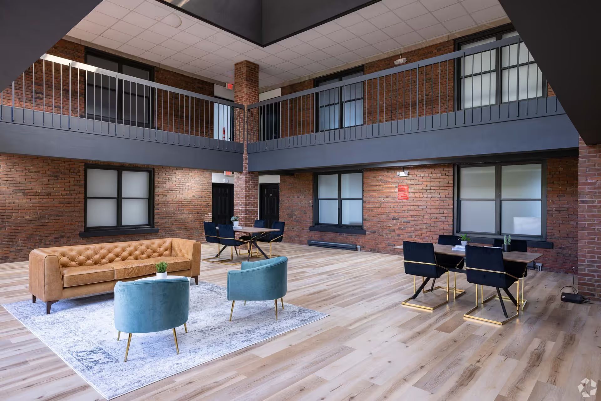 A living room with a couch , chairs , and a table.